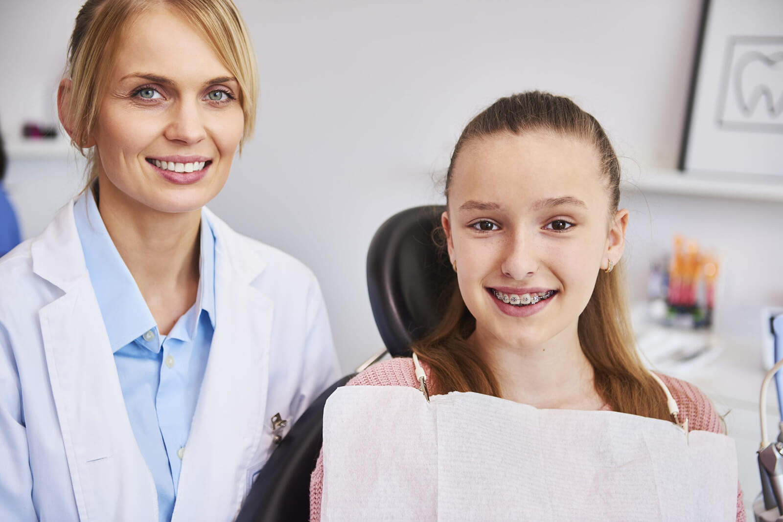 smiling-female-orthodontist-child-dentist-s-office